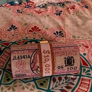 This is a glitter money purse with a detachable strap.